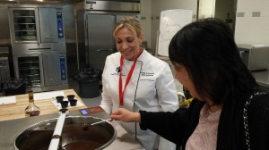 Chef Cindy Schwanke watching over Karen Perlis as she dips!