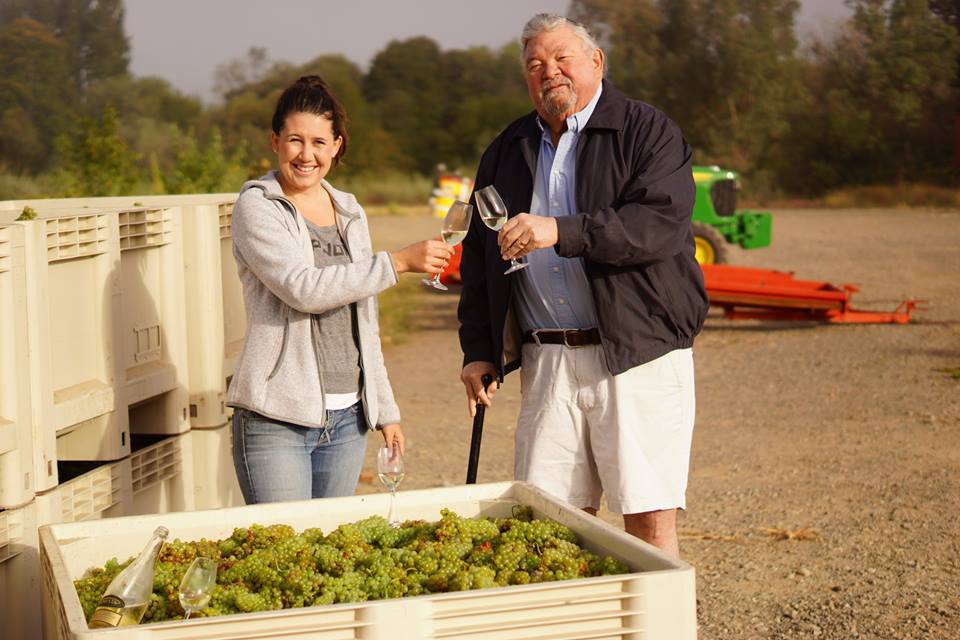 Amista Vineyards Winemaker Ashley Herzberg owner Mike Farrow toast on Saturday, August 13, 2016 over the first grapes harvested in Dry Creek Valley for the 2016 harvest season. This chardonnay is used to make the winery's Sparkling Blanc de Blancs